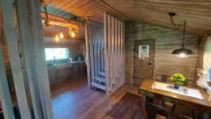a room with a wooden floor and a hallway with a table at Domek Izdebska chata in Izdebno +29 photos