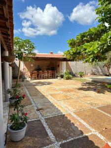 a stone walkway leading to a house at Casa com Piscina Privativa na Lagoa do Paraíso - John House Paradise in Jijoca de Jericoacoara
