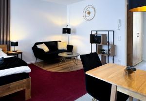 a living room with a bed and a couch at King Clusion in Koblenz