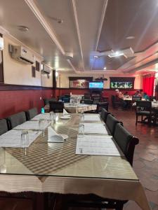 a conference room with a long table and chairs at Maharani Hotel in Kozhikode