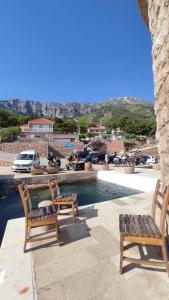 two chairs sitting next to a swimming pool at Apartments Villa Ypsilon in Sveta Nedelja +30 photos