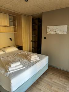 a bedroom with a bed with towels on it at Holiday Home Ahil 10 in Pakoštane +12 photos