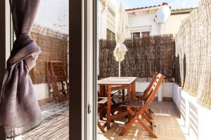 a patio with a table and chairs on a balcony at Apartamento con terraza privada cerca de la playa in Valencia
