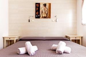 a bedroom with a bed with towels on it at Apartamento con terraza privada cerca de la playa in Valencia