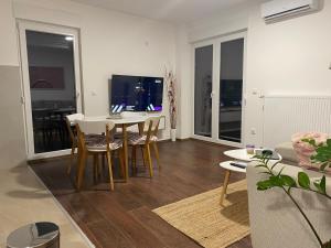 a living room with a dining room table and chairs at LadyDi apartman in Banja Koviljača +26 photos