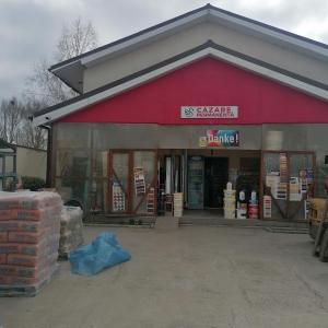 a store with a red building with a lot of windows at Lebada Neagră in Schitul