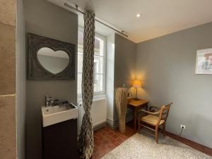 a bathroom with a sink and a mirror at La Maison du Chablisien in Chablis +20 photos