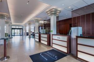 a lobby of a store with a row of counters at Courtyard by Marriott Amsterdam Airport in Hoofddorp