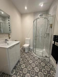 a bathroom with a shower and a toilet and a sink at The Old Bakery in Fowey +14 photos