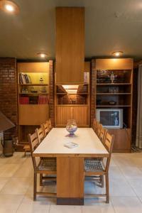 a dining room with a table and chairs and a kitchen at Retro House in Rafina