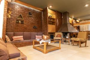 a living room with a couch and a brick wall at Retro House in Rafina