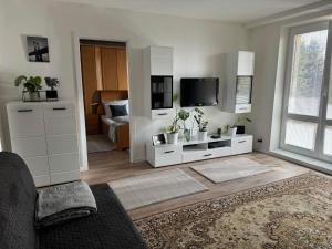 a living room with a couch and a tv at Ubytovanie pri hradbách in Levoča