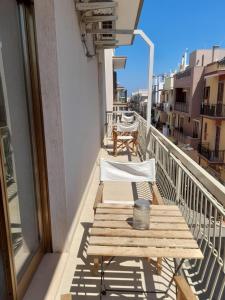 a balcony with a table and chairs on a building at B&B familiare Arcadia Polignano in Polignano a Mare +22 photos