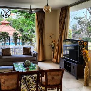 a living room with a couch and a fish tank at Khushana Villa by Baywatch stayzz in Chennai +4 photos