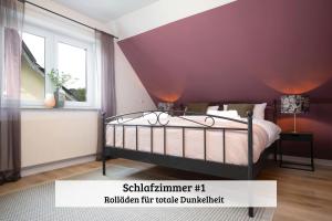 a purple bedroom with a bed and a window at LenHaus Sundern - Ferienhaus mit Kamin & Garten in Sundern