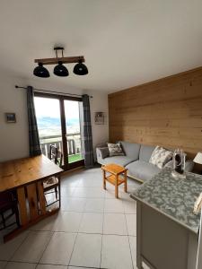a living room with a couch and a table at Appartement centre Saint Gervais-Vue imprenable in Saint-Gervais-les-Bains