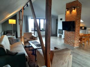 sala de estar con sofá y chimenea de ladrillo en Świerkowe Zacisze Nałęczów, en Nałęczów