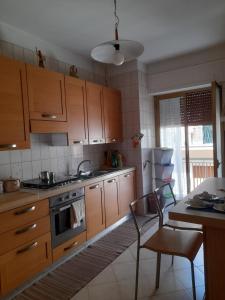 a kitchen with wooden cabinets and a stove top oven at B&B familiare Arcadia Polignano in Polignano a Mare