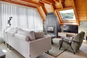 a living room with a large couch and a tv at Les Marmottes by FeelFree Rentals in Vielha