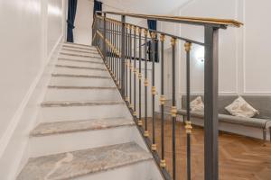 a staircase with black and white railings in a house at Duomo Smart Suites in Milan
