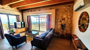 a living room with a couch and a television at Kaleli Deluxe Homes in Kas