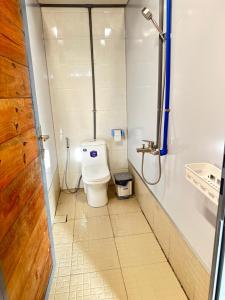 a small bathroom with a toilet in a stall at Bến Hồ Homestay in Xã Gia Tân +60 photos