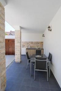 een eetkamer met een tafel en stoelen bij Villa Galleria in Sukošan