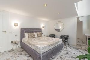 a bedroom with a large bed and a mirror at Duomo Smart Suites in Milan