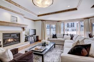 a living room with a couch and a fireplace at Platinum 2 Bedroom Vacation Rental In The Heart Of Vail That Includes Ski Valet, Ski Deck, Rooftop Pool, Panoramic Views in Vail