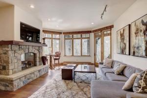 a living room with a couch and a fireplace at 4 Bedroom Luxury Townhome In Lionshead Village in Vail