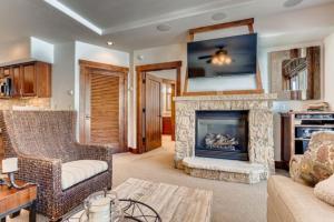 a living room with a fireplace and a couch at Crystal Peak Lodge 3 Bedroom Ski In, Ski Out Slopeside Condo At The Base Of Peak 7 in Breckenridge