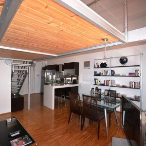 a dining room and kitchen with a table and chairs at Loft Esclusivo - 5 Stars in Biella