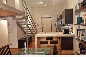 a kitchen with a spiral staircase in a room at Loft Esclusivo - 5 Stars in Biella +4 photos