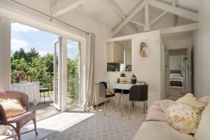 a living room with a couch and a table at Enchanted Retreats at West Ford Devon in South Molton