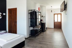 a bedroom with a bed and a wooden floor at Къщи за гости БРИК in Sapareva Banya