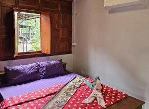 Postelja oz. postelje v sobi nastanitve Nipatra Homestay
