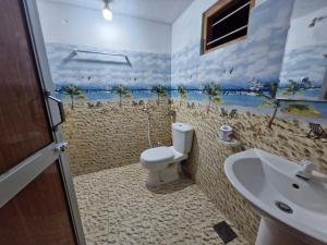 a bathroom with a toilet and a sink at TRINCO VISTARA GUEST House APARTMENT in Trincomalee +54 photos