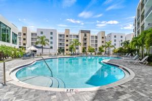 a large swimming pool in front of a building at Resort Pool & Spa, Fitness Center, Pet Friendly, Waterfront Condo in Downtown! in Sarasota