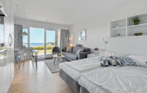 a bedroom with a bed and a living room at Cozy Apartment In Allinge With Wifi in Allinge