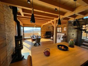 a kitchen and living room with a wood stove at Chalet Mont-Reve in Font Romeu Odeillo Via