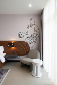 a bedroom with a basketball player mural on the wall at Avo sports résidence, Diamniadio in Dakar