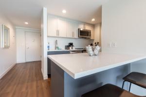 a kitchen with white cabinets and a counter top at Luxury Apt Near Charles River in Cambridge