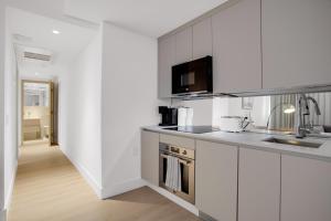 a kitchen with white cabinets and a sink at Vonder Miami Beach - Unit 6 in Miami Beach