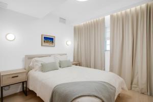 a white bedroom with a bed and a window at Vonder Miami Beach - Unit 6 in Miami Beach