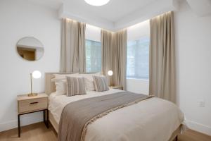 a white bedroom with a bed and a window at Vonder Miami Beach - Unit 6 in Miami Beach