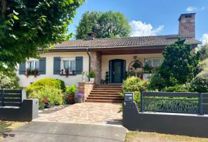 a house with a blue door and stairs at Le Gîte de Brigitte ! in Saint Die