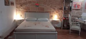 A bed or beds in a room at Palazzo Saraceno apartments-Antico Rifugio