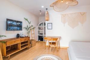 a living room with a desk and a table at Dupadi Villa Jogja With Privatepool in Jetis