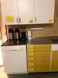 a kitchen with white cabinets and a counter top at Andsnes Velhus in Loppa