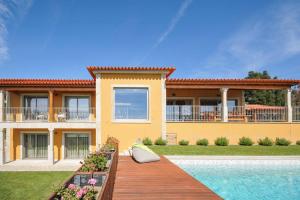 a house with a swimming pool in front of it at Casa Tranquilo in Refoios do Lima